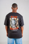 Person wearing a black t-shirt with a graphic design and text on the back, standing against a plain background.